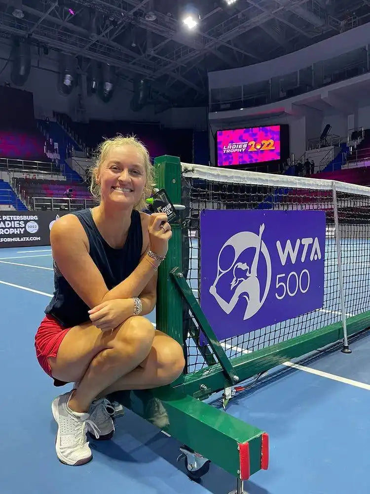 Tennis net with WTA 500 banner.