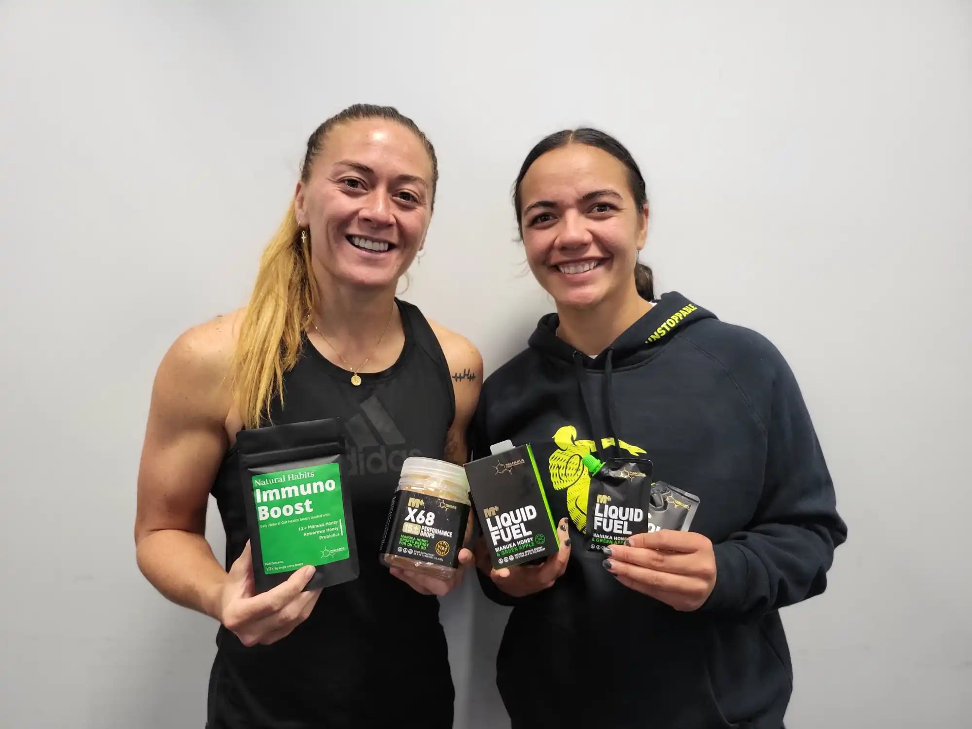 Two women holding health supplements.